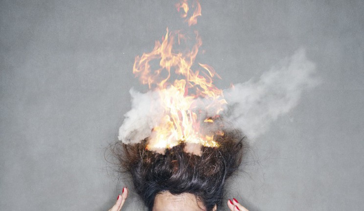 brunette woman head hair on fire